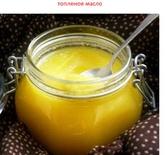 a glass jar filled with yellow liquid on top of a polka dot cloth