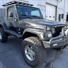 a black jeep parked in front of a building