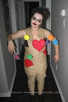 a woman dressed up in a costume with buttons on her chest and face painted like a heart