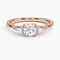 Cushion Cut Quinn Diamond Engagement Ring - 14K Rose Gold. Captivating tapered baguette diamonds are prong set in this elegant ring, brilliantly framing the center gem. With a delicate band, this ring evokes classic beauty (1/5 total carat weight). Classic Rose Gold Diamond Ring With Baguette Diamonds, Classic Rose Gold Ring With Baguette Diamonds, Classic Rose Gold Rings With Baguette Diamonds, Rose Gold Baguette Diamonds Wedding Ring, Rose Gold Diamond Baguette Cut Ring, Elegant Rose Gold Baguette Cut Wedding Ring, Timeless Rose Gold Diamond Ring With Baguette Cut, Rose Gold Diamond Ring With Baguette Diamonds For Anniversary, Timeless Rose Gold Baguette Cut Diamond Ring