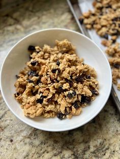 a white bowl filled with granola on top of a counter