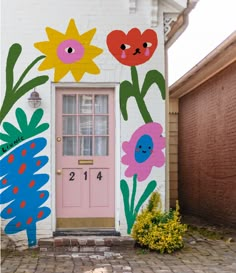 a painted house with flowers on the front door