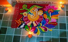 a colorful painting on the wall in a room with candles and lights around it,