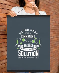 a woman holding up a sign that says never mess with a chemist because we find solution