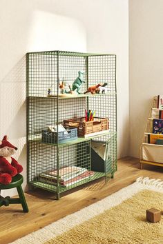 a child's room with toys and bookshelves in the corner, including a teddy bear