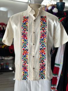 Exceeding Expectations: Your Satisfaction is Our Priority At Oaxaca Mia, we take pride in delivering exceptional customer service. Our friendly and helpful team is dedicated to ensuring your shopping experience is top-notch. Don't just take our word for it - check out our positive feedback from satisfied customers. Introducing our Brand New, Never-Used 100% Authentic Mexican Guayabera - a true gem in our collection. 100% Authentic Mexican Shirt This shirt is a vision of elegance in black, crafted from a blend of Manta and Cotton for both style and comfort. Size Medium, the measurements are as follows: Chest: 23" Waist: 23" Shoulder: 20" Shoulder to Hem: 28" *Note: The floral wall pattern remains consistent, but the embroidery colors may vary from shirt to shirt, adding a unique touch to ea Mexican Wedding Shirts For Men, Mens Guayabera Shirts, Embroidery Men, Mexican Shirt, Mexican Shirts, Wall Pattern, Guayabera Shirt, Mexican Embroidery, Authentic Mexican