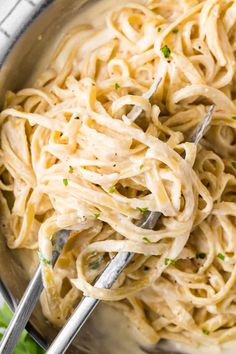 a bowl filled with pasta and garnished with parsley