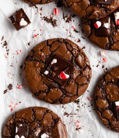 chocolate peppermint cookies with white and red candy canes on top, one broken in half