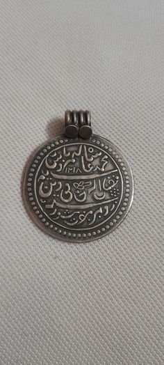 Handmade 92.5 Sterling Silver Hammer Stamped Islamic Religious Urdu Letter Aayet A Qaraan Prayer (dua)  Holy words Oxidized Pendant Made By my shop member Primary Color of Pendant is oxidized Silver Pendant Details : Weight of Pendant is 13.9 Gms. Length of Pendant is 4.6 cm.with Loop Width of Pendant is 3.7 cm Thickness of Pendant is 1 mm inner diameter of Pendant Loop is 7 mm It's a totally Handmade Islamic muslim Holy Pendant from Rajasthan state northern India Traditional Silver Necklace For Eid, Traditional Sterling Silver Coin Necklaces, Traditional Coin Necklace Gift, Letter Pendants, Oxidized Silver, Hammered Silver, Handmade Pendant, Handmade Pendants, Sterling Silver Pendant