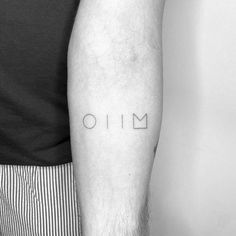 a man's arm with the word omi tattooed on it