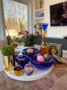 a table topped with blue plates and bowls filled with different types of food on top of it