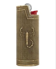 a brass colored lighter with a lobster on it