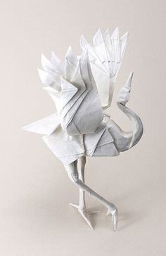 an origami bird is standing on its hind legs