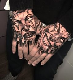 two hands with faces painted on them and one hand holding the other's fingers