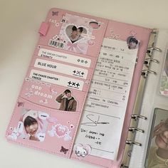 an open pink planner book with pictures on it