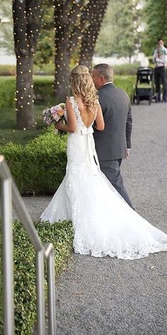 the bride and groom are walking down the path