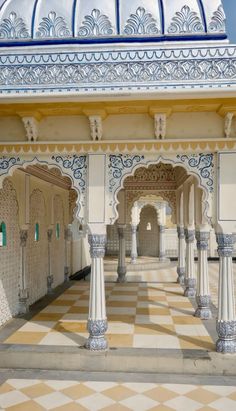 an ornate building with columns and tiled floors