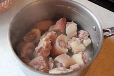 meat and vegetables are being cooked in a pot