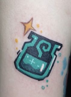 a small tattoo with a blue and green design on the leg