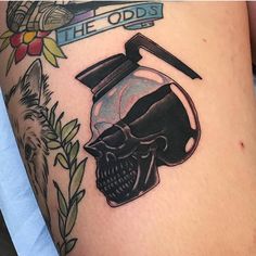 a tattoo with a skull and a flask on it's arm, which reads the odds