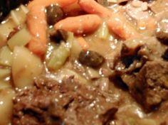 the meat and vegetables are mixed together in this stew with gravy on top