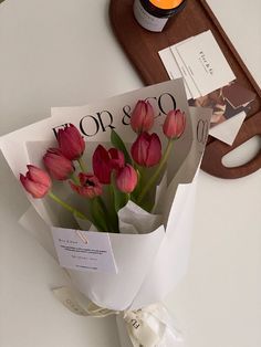 a bouquet of pink tulips wrapped in paper