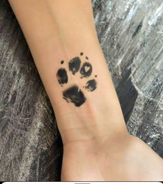 a person with a paw print on their wrist and foot in the middle of it