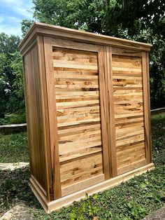 a large wooden storage box in the grass