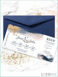 an envelope and wedding card with gold glitters on the inside, in front of a marble background