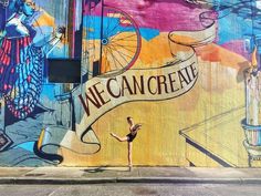 a woman standing in front of a colorful wall with a sign that says we cancreve