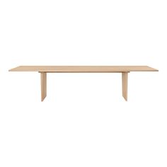 a wooden table sitting on top of a white wall