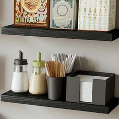 two black shelves holding various items on them