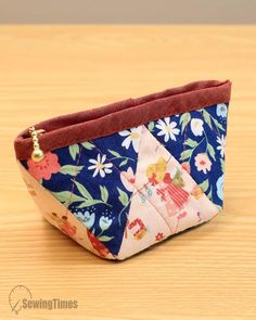 a small zippered pouch sitting on top of a wooden table