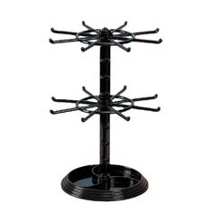 a black metal rack with multiple hooks on it's sides and two circular holes in the middle