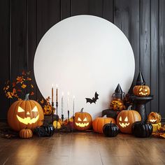 halloween pumpkins with carved faces and candles in front of a large white circle on a wooden floor