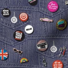 the back pocket of a jean jacket with various badges on it