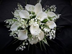 a bouquet of white flowers on a black background