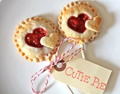 two heart shaped pies on top of a white plate with a red and white tag