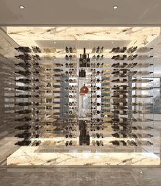 a room filled with lots of bottles of wine on the wall and floor, in front of a large mirror