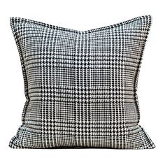 a black and white pillow on a white background