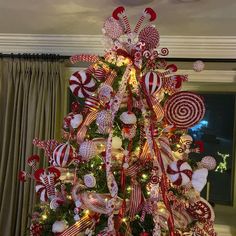 a christmas tree decorated with red and white candy canes