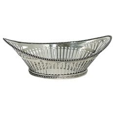 a silver bowl with beading on the rim and sides is shown against a white background