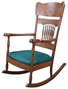 a wooden rocking chair with a blue cushion