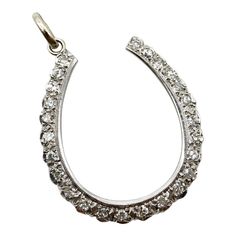 This is part of Chairish’s Fine Jewelry assortment.  Circa 1900, this 12k gold lucky horseshoe pendant contains 25 sparkling single cut diamonds bead set with bright cut work. The setting has scalloped edges along the bottom outside border; the inside border is a nice clean line that balances the intricate opposite edge in a nice composition. The result is an illusion setting that captures more light to make the diamonds appear larger. We’ve converted this piece from a pin to a pendant by removi Classic Horseshoe Diamond Accents Jewelry, Classic Horseshoe Jewelry With Diamond Accents, Horseshoe Pendant, Lucky Horseshoe, Bead Set, Scalloped Edges, Accessories Jewelry Necklace, Cut Work, Early 20th Century