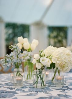 coastal grandmother wedding inspiration, navy blue and white wedding, dainty white florals, small vases, floral mixing, simple florals, hydrangeas, tulips, roses, navy embroidered linens Navy Blue White Wedding, Stradley Davidson, Bud Vases Wedding, Reception Florals, Blue White Weddings, Tulip Wedding, Hydrangeas Wedding, Cream Wedding, Wedding Table Flowers