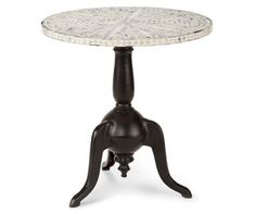 an old fashioned table with a white marble top and black legs, on a white background