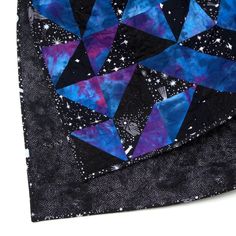 a close up of a piece of cloth with blue and purple designs on it,