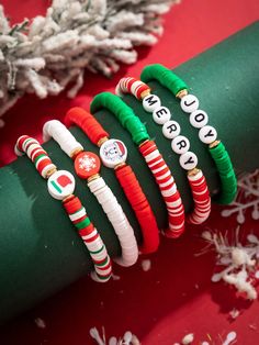 christmas bracelets are arranged on top of a green roll