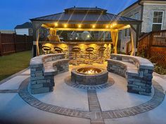 an outdoor fire pit with lights on it