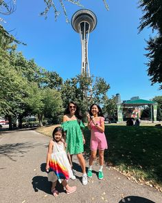 two women and a child standing in front of the space needle